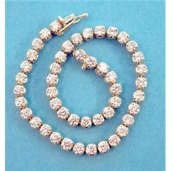 An 18ct gold and diamond line bracelet claw set 47 round cut stones, 7.5ins. £1600-1800...