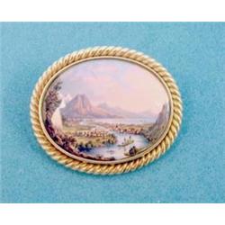 A Swiss polychrome enamelled oval brooch depicting a study of Interlaken, in rope twist frame £80...