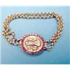 Image 1 : A Georgian gold oval bracelet clasp with hair work monogram framed by a border of flat cut garnet...