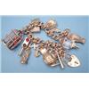 Image 1 : A 9ct gold curb link charm bracelet with padlock clasp, the 12 various charms including a parrot...