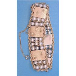 A 14k gold flexible bracelet designed as 6 star engraved rectangular plaques spaced by 3 rows of...