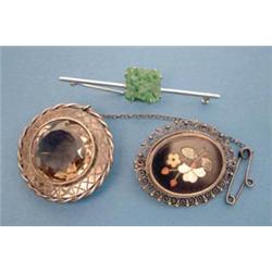 A Continental oval brooch inset pietra dura floral spray in an 800 standard filigree frame, a whi...