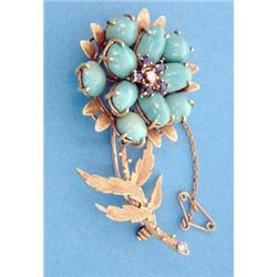 A gold brooch designed as a single chrysanthemum, set turquoises, sapphires and diamonds £150-250...