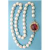 Image 1 : A single row uniform cultured pearl necklace with circular gold clasp set with a cabochon amethys...