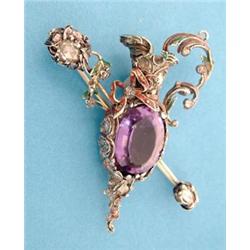 A late 19th century gold and silver brooch designed as a ewer and baton, polychrome enamelled and...