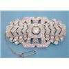 Image 1 : A French white gold Art Deco diamond set plaque brooch of pierced geometric buckle shape, the cen...