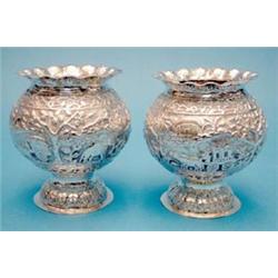 A pair of Indian white metal globular vases, 4.5ins. £120-150...