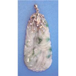 A carved jade pendant on a diamond set 14k gold mount £200-300...