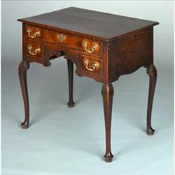 George III oak kneehole lowboy having a moulded edge, one long and two box drawers with brass swa...