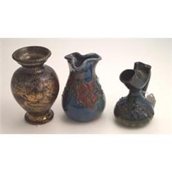 Eltonware bulbous shaped ewer with raised foliate decoration on a mottled blue, green and brown g...