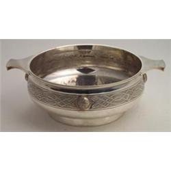 Silver plated two handled bowl decorated with a Celtic design band and with raised Celtic medalli...