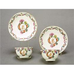 A pair of Chinese export teabowls and saucers, finely decorated with initials ISC within shell a...