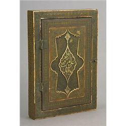 A Near-Eastern manuscript box, the hinged cover decorated in relief with arabesques and an inscri...