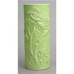 A tall green-glazed brushpot by Li Yuchen, carved in high relief with cranes and deer under pine...