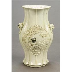 A white-glazed vase, mark of Sun Guike, of lobed baluster form carved with shaped-panels depictin...