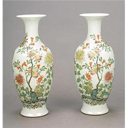 A pair of 'famille-rose' vases each of tapering ovoid form with trumpet neck, painted with chrysa...