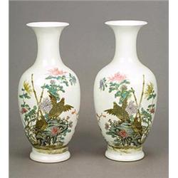 A pair of 'famille-rose' vases each of ovoid form with trumpet neck, painted with a pair of quail...