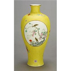 A yellow-ground 'famille rose' vase decorated with panels of flowers and birds, on an incised yel...