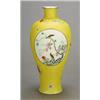 Image 1 : A yellow-ground 'famille rose' vase decorated with panels of flowers and birds, on an incised yel...