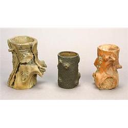 Three Yixing brushpots each carved in imitation of a tree trunk, one with a sixteen character ins...