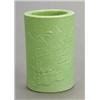 Image 1 : A green-glazed brushpot, circa 1900, carved in low relief with a landscape, the base with four ch...