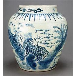 A large oriental late Ming style jar, decorated in underglaze blue with scaly beasts in a landsca...