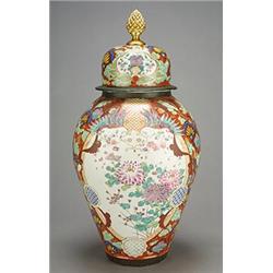 A large oriental export ovoid vase and cover enamelled in colours with panels of flowers on an ir...