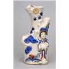 Image 1 : An Arita vase in the form of a lady holding a basket and standing by a naturalistically modelled...