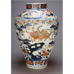 A large Japanese Imari ovoid vase, decorated in underglaze blue, iron red and gilt with a crane a...