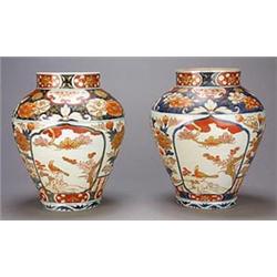 A pair of Japanese Imari ovoid vases, each decorated with lappet shaped panels of birds and flowe...