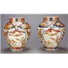 Image 1 : A pair of Japanese Imari ovoid vases, each decorated with lappet shaped panels of birds and flowe...