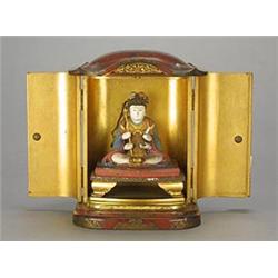 A Japanese red lacquer Zushi, the doors with chased gilt metal mounts, the interior in gilt with...