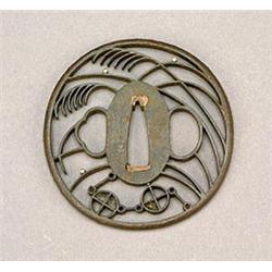 A Japanese iron Tsuba, finely pierced with stylised tendrils and droplets in gold, 7.2cm, probabl...