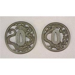 A pair of Japanese iron Tsuba, finely cast and pierced with scaly dragons, signed Hiotsuyanagi To...