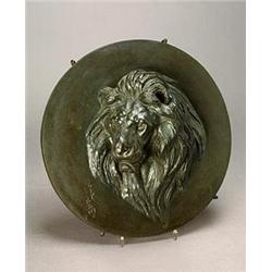 A Japanese bronze round plaque modelled in high relief with a lion head, 37cm, signed (see illust...