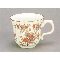 A Continental hardpaste porcelain fluted coffee cup, probably Alcora, with flared rim and painted...