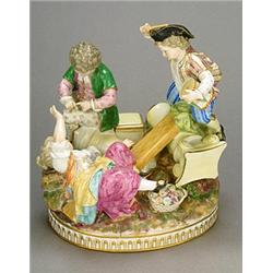 A Meissen (outside decorated) group of three children at play, modelled amonst ruined columns, on...