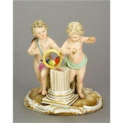 A Meissen (outside decorated) group of two putti with a parrot, modelled standing either side of...