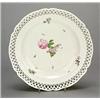 Image 1 : A Berlin reticulated dessert plate, painted with scattered sprays of flowers, within a shaped rim...