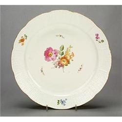 A pair of Berlin (KPM) ozier-moulded chargers, sparsely painted with deutsche Blumen, within ozie...