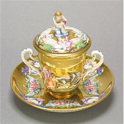 A Continental porcelain Naples style two-handled cabinet cup, cover and stand, moulded con basso...