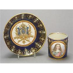 A Sevres-style dark-blue-ground coffee can and saucer, the can painted with an oval portrait meda...