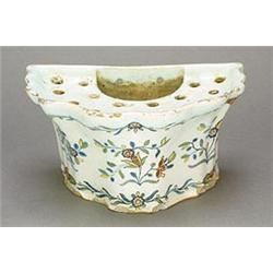 A French faience demi-lune bough-pot (bouquetier), of flared and fluted form, painted in shades o...