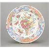 A North Italian faience polychrome chinoiserie soup plate, painted and gilt with flowering shrubs...