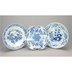 Three various blue and white Delft plates, comprising, an example with a shaped rim painted with...