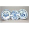 Three various blue and white Delft plates, comprising, an example with a shaped rim painted with...