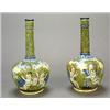 A pair of Italian maiolica Castelli-style bottle vases, painted with scenes of putti in an Italia...