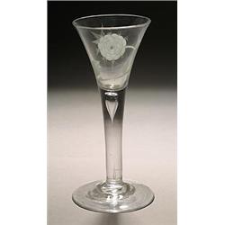 A plain-stemmed wine glass of Jacobite significance, the drawn trumpet bowl engraved with a rose,...