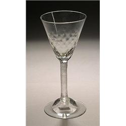 An incised twist wine glass, the funnel bowl with honeycomb-moulded lower section, on a domed foo...