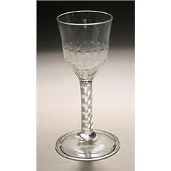 An airtwist wine glass, the ogee bowl with a hammered flute lower section, the stem with a seven-...